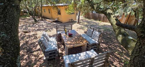 a table and chairs in front of a cabin at La cabane - Nature et Spa in Aurons