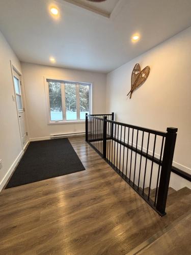 a room with a staircase with a butterfly on the wall at Gîte du Ruisseau in Lamarche