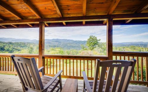 two chairs on a porch with a view of the mountains at Journey's End in Gatlinburg