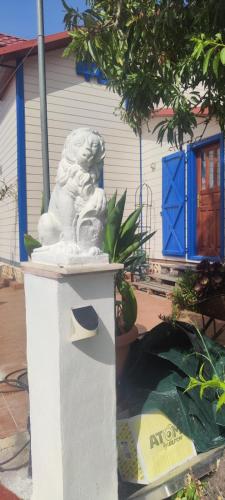 a white lion statue sitting in front of a house at Chalet, breathtaking sea view with large jacuzzi in Almuñécar