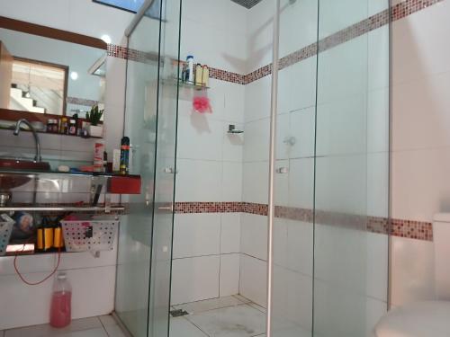 a shower with a glass door in a bathroom at Angelo&Gabi in Ananindeua
