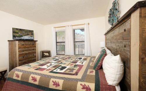 a bedroom with a large bed with a wooden headboard at Oak Square 305 in Gatlinburg