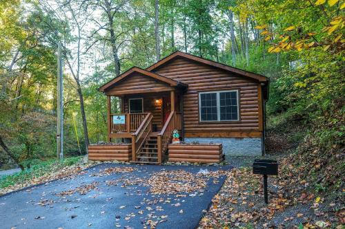 a log cabin in the woods with a staircase at Bear Trail 625 in Gatlinburg