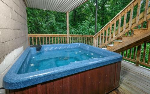 a hot tub on the deck of a house at Bear Hugs 1126 in Gatlinburg