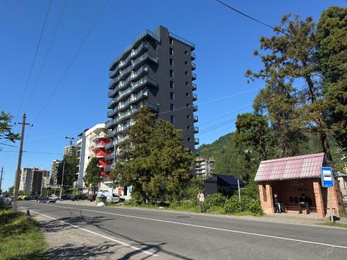 a tall apartment building on the side of a street at Gonio Studio in Batumi in Kvariati