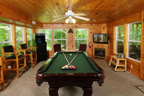 a living room with a pool table in a cabin at Mountain Therapy 1123 in Gatlinburg