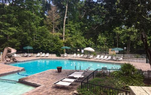 a large swimming pool with chairs and a slide at Smoky Getaway in Gatlinburg