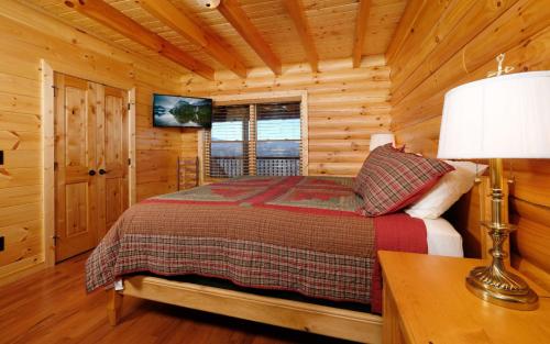 a bedroom with a bed in a log cabin at New Fox Lodge in Gatlinburg