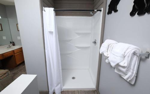 a bathroom with a shower with white towels at Honey Bear Heaven in Gatlinburg