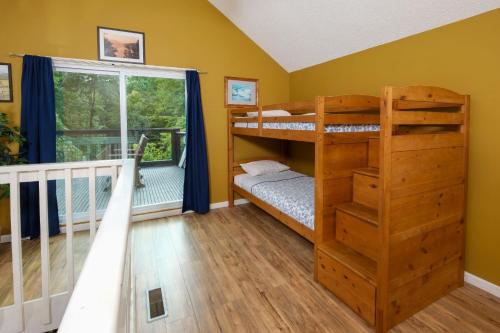 a bedroom with two bunk beds and a window at Bear Hugs in Gatlinburg