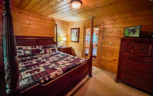 a bedroom with a bed in a log cabin at Skinny Dipping in Gatlinburg