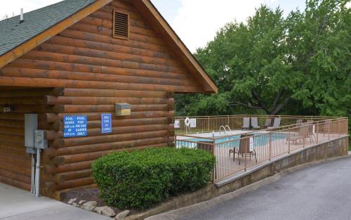 a wooden building with a pool and a deck at Bear Footin Heaven in Pigeon Forge