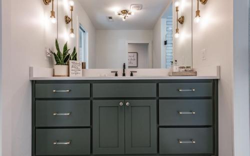 a bathroom with a sink and a mirror at Farmhouse in the Burg in Gatlinburg