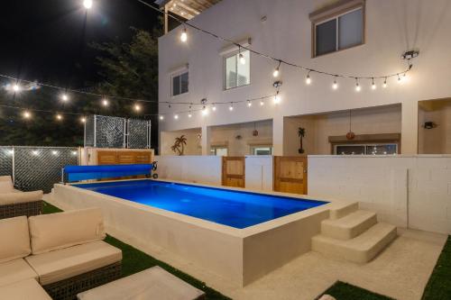 a pool in the backyard of a house at night at 3 Story Home 3BR 2BA with Rooftop View and Heated Pool in La Choya