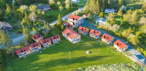 an aerial view of a house with a yard at Hunts Point 1-BR Coastal Retreat - Cottage # 6 in Summerville Centre