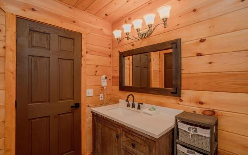 a bathroom with a sink and a mirror at Absolute Heaven in Gatlinburg