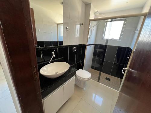 a bathroom with a sink and a toilet at Residencial Nicole in Florianópolis