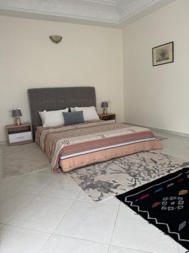 a bedroom with a large bed and a rug at Villa Séphira in Fès
