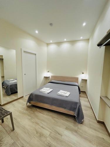 a bedroom with a bed with two towels on it at Nuovo b&b Al Centro NICOSIA in Nicosia