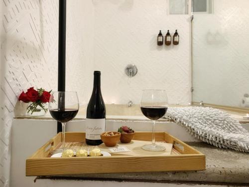 a wooden tray with two glasses of red wine at Cacao Boutique Hotel in Antigua Guatemala