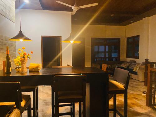 a dining room with a black table and chairs at Erin Orr Villa in Wadduwa