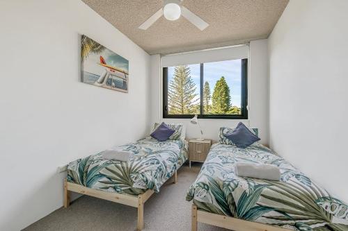 a bedroom with two beds and a window at Tasman Towers 5 3 Munster Street in Port Macquarie