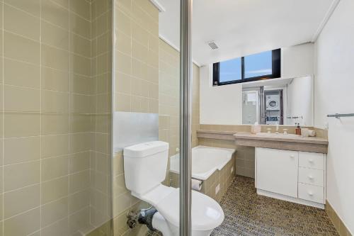 a bathroom with a toilet and a sink at Tasman Towers 5 3 Munster Street in Port Macquarie