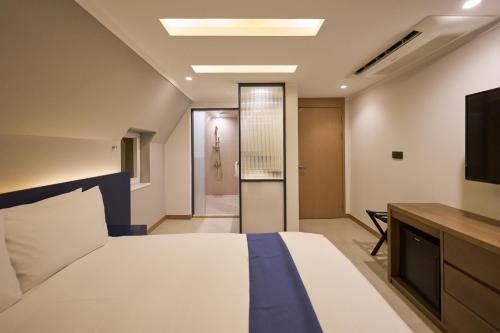 a hotel room with a bed and a television at Blueduck hotel in Seoul