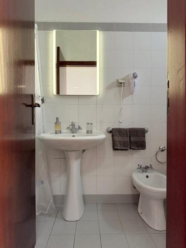 a white bathroom with a sink and a toilet at Beautiful Room in the montains in Estrela