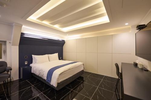 a hotel room with a bed and a television at Blueduck hotel in Seoul