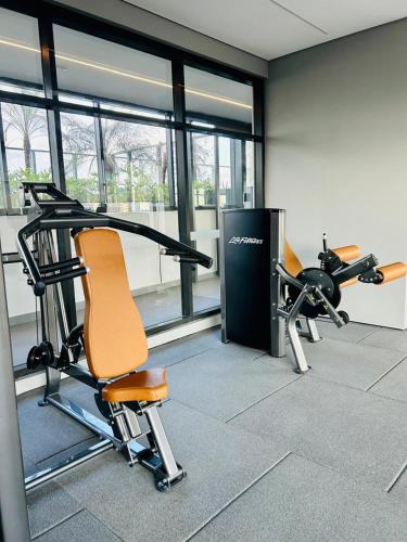 a gym with two exercise bikes in a room with windows at Studio 1805 - A Poucos Metros do Allianz Park in Sao Paulo