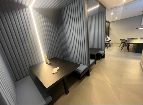 a restaurant with benches and a table with a napkin on it at Studio 1805 - A Poucos Metros do Allianz Park in Sao Paulo
