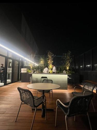 a room with a table and chairs and lights at Studio 1805 - A Poucos Metros do Allianz Park in Sao Paulo