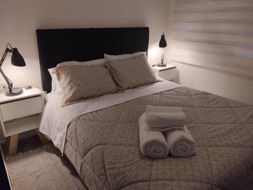 Una cama o camas en una habitación de Cabañas Económicas Temuco