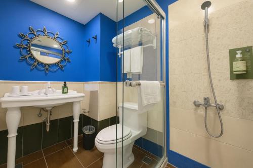 a bathroom with a toilet and a sink and a shower at Elizabeth Hotel in Taichung