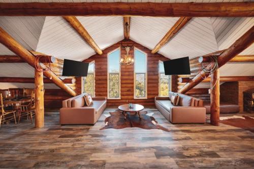 a living room with two couches and a table at Red Hawk Ridge SD Mag Design Winner in Alpine