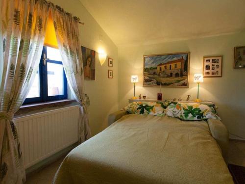 a bedroom with a bed with two lamps and a window at Holiday home in Dobrinj with swimming pool in Dobrinj