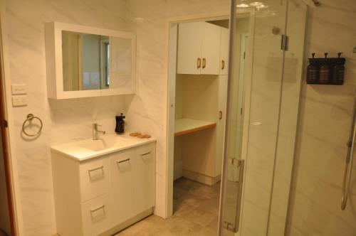 a bathroom with a sink and a shower at Pokolbin Village Estate in Pokolbin