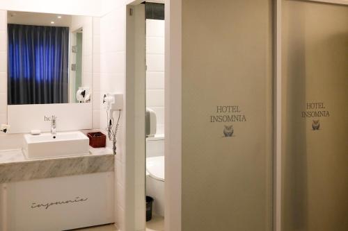 a bathroom with a sink and a toilet and a mirror at 호텔 인썸니아 Hotel Insomnia 失眠酒店 in Daegu