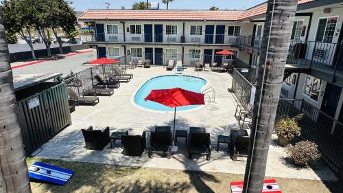 an overhead view of a pool with chairs and umbrellas at Studio 6 Suites San Ysidro CA San Diego South Bay in San Ysidro, San Diego