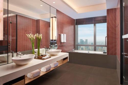 a bathroom with two sinks and a large window at Grand Hyatt Changsha-Close to Helong Sports Center in Changsha