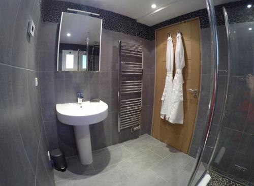 a bathroom with a sink and a shower at Les Hortensias in Lantosque