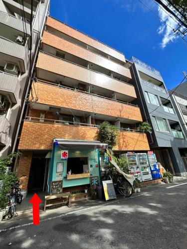 a building with a red arrow pointing to a store at Wise Park Mukojima in Tokyo