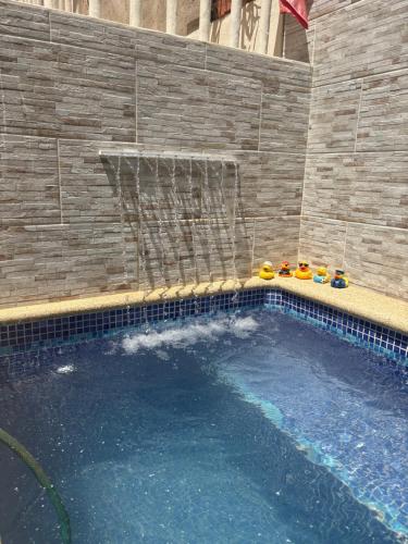 a swimming pool with a basketball hoop in a building at Casa Moka Amarilla in La Peñita de Jaltemba