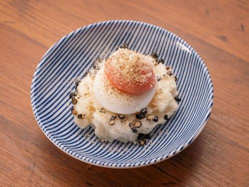 a plate with an egg on top of a dessert at Graces Hotels in Inzai