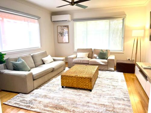 a living room with a couch and a coffee table at Julijana's Place Richmond - Walk to the MCG in Melbourne