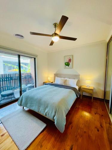 a bedroom with a bed and a ceiling fan at Julijana's Place Richmond - Walk to the MCG in Melbourne