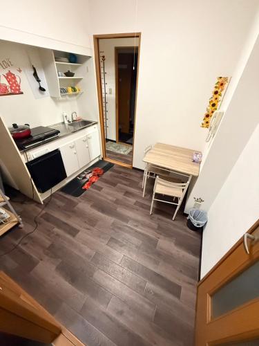 a kitchen and dining room with a table and a counter at 華宝民泊 in Wada
