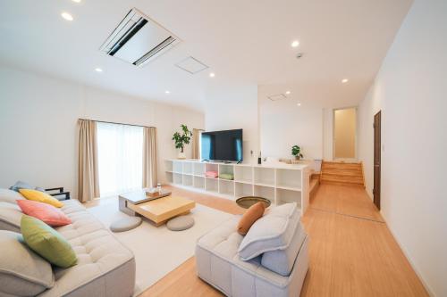 a living room with two couches and a tv at Starry Stay Villa NISHIATAMI in Atami