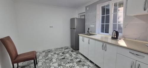 a kitchen with a sink and a refrigerator at villa gardens in K'obulet'i